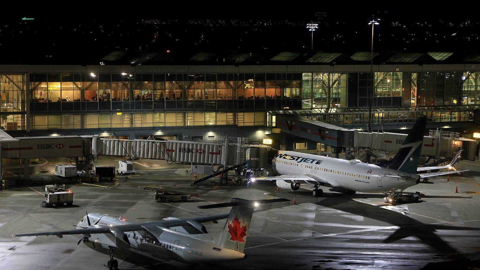A row of closed passport control booths at an international airport with roller shutters lowered over the counters.
